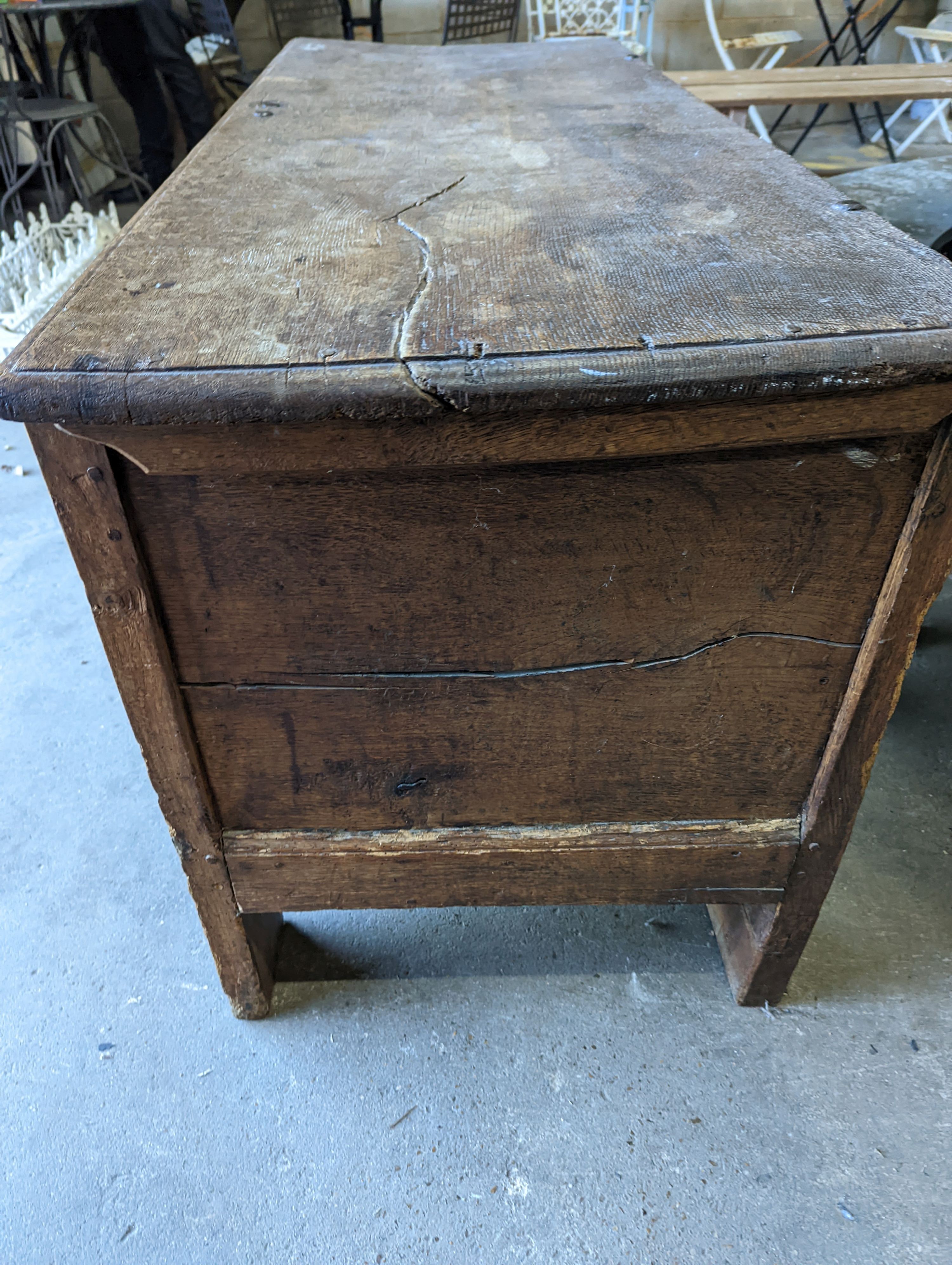 A large 17th century oak panelled coffer, length 147cm, depth 58cm, height 74cm